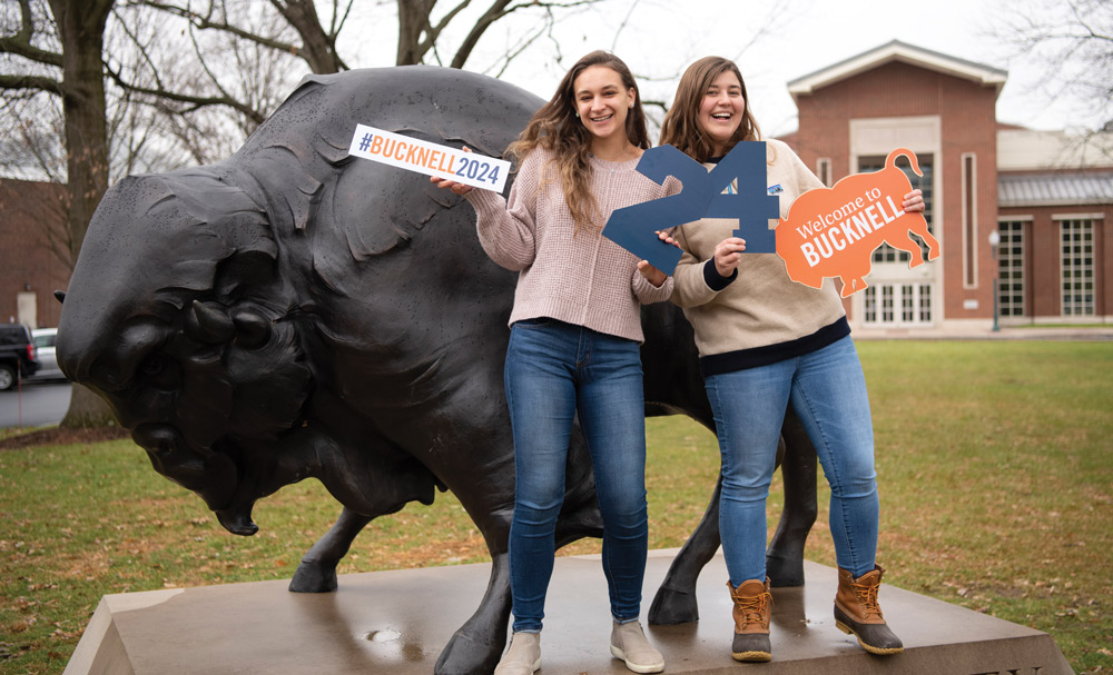 Bucknell students posing with spirit signs