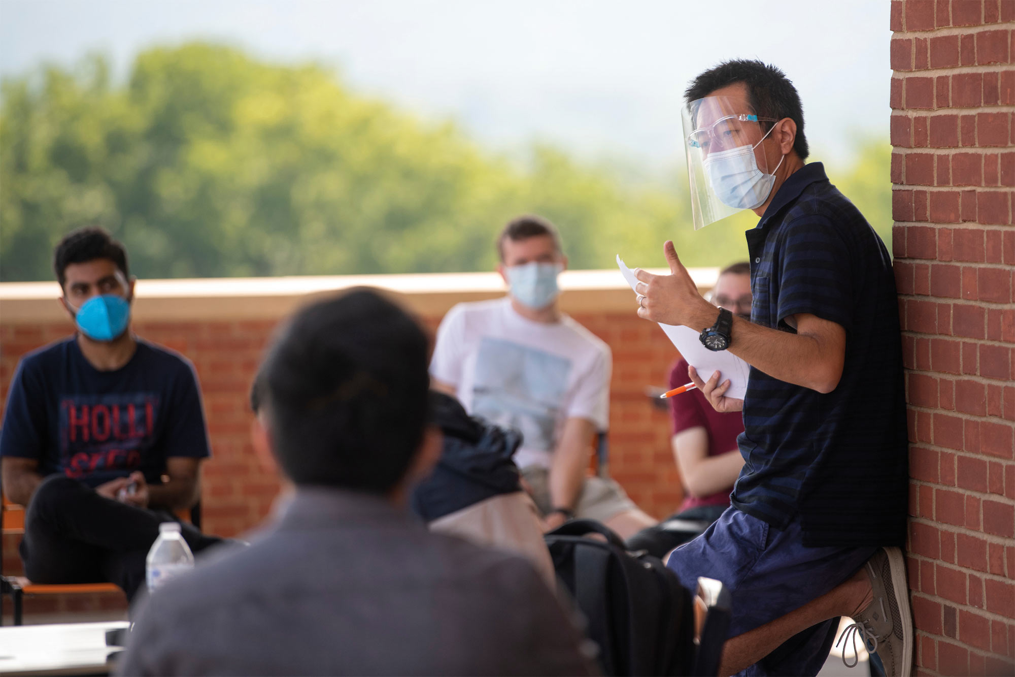 Professor Kat Wakabayashi takes his teaching to a new level — the outdoor balcony on the second floor of Academic East.