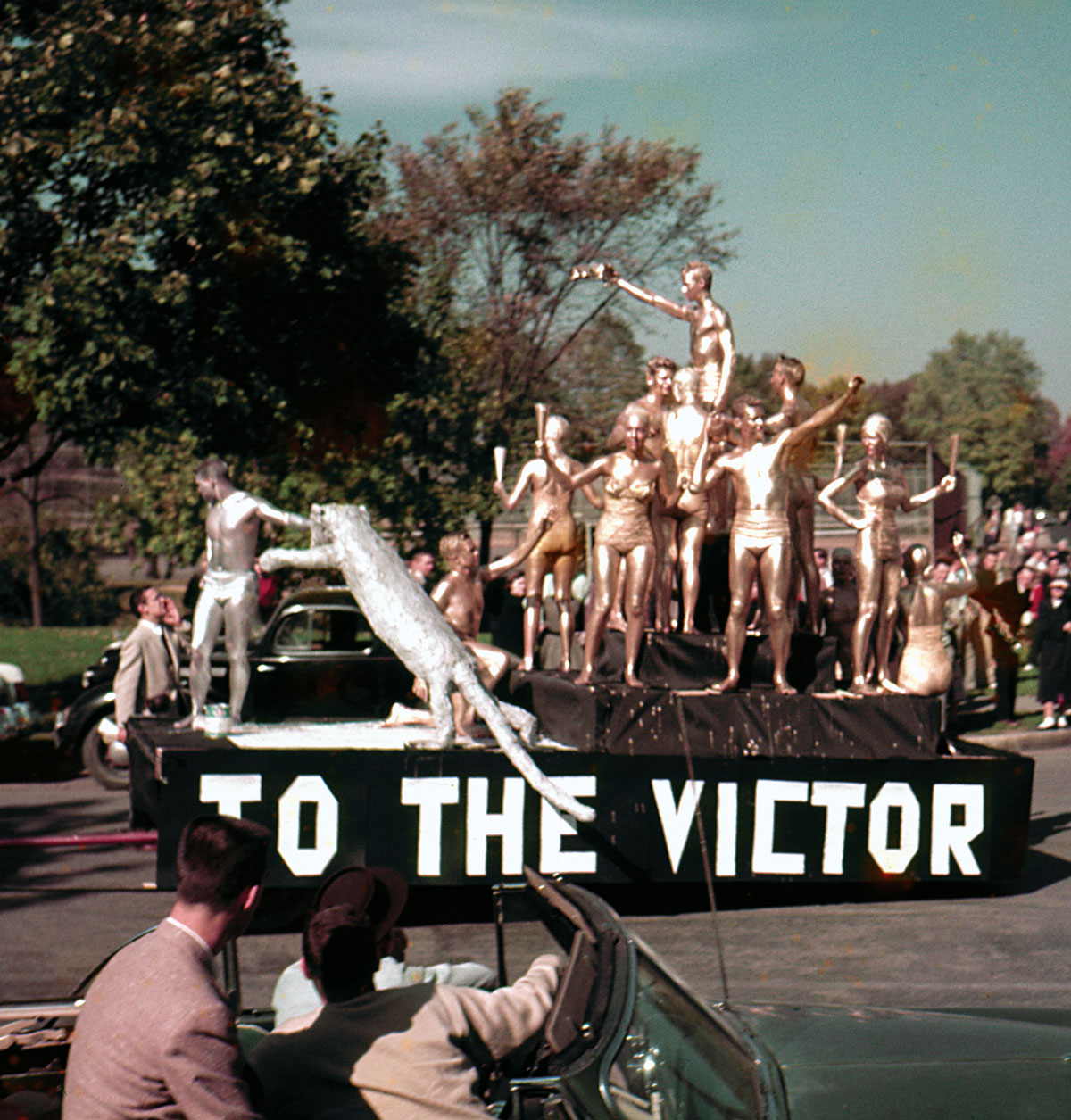 Members of Tau Kappa Epsilon and Kappa Kappa Gamma dazzle on their first-place Homecoming float in 1954.