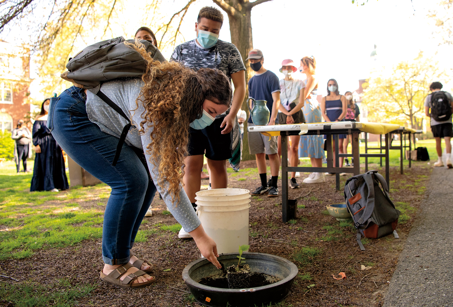 student participating in an interactive libation and planting ceremony