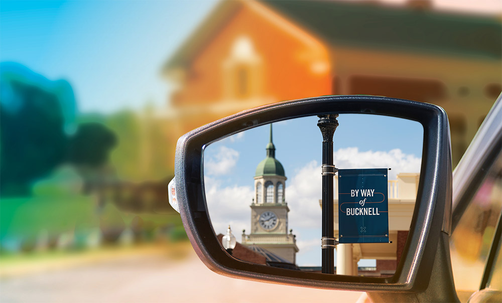 Bucknell campus scene from  the side mirror of a car