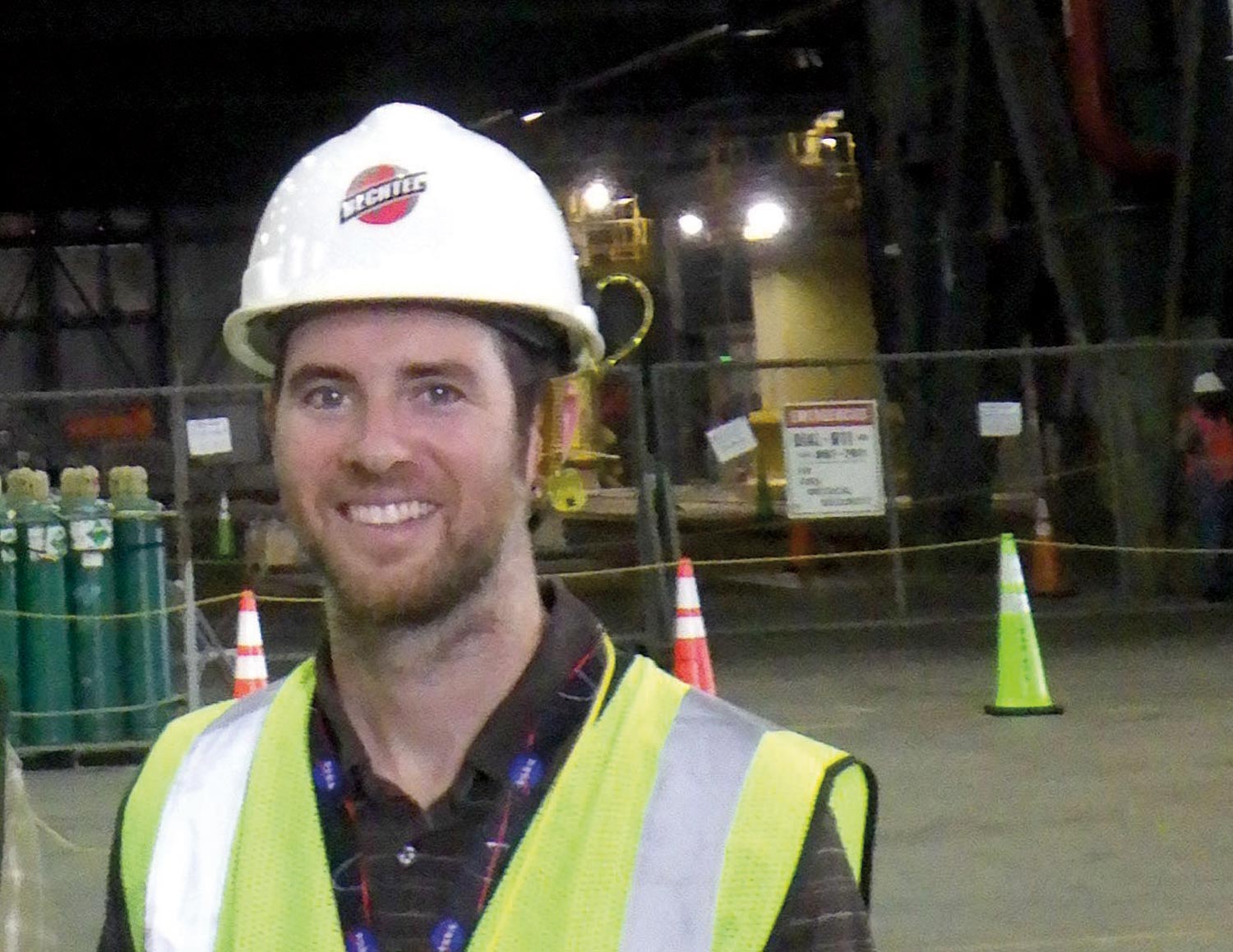 photo of Kevin MacLeod on site, smiling wearing a hard hat and safety vest