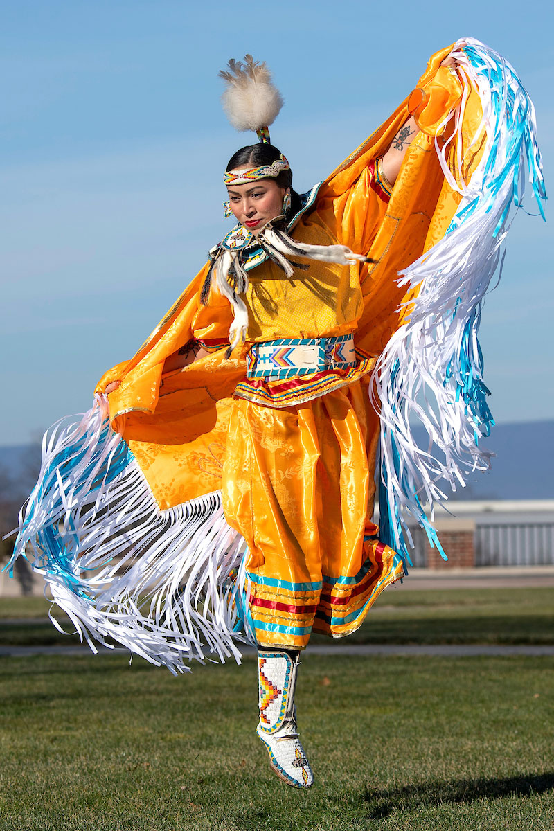 Sierra Pete M’22 practices a powwow dance on the Malesardi Quad wearing ceremonial attire that she created