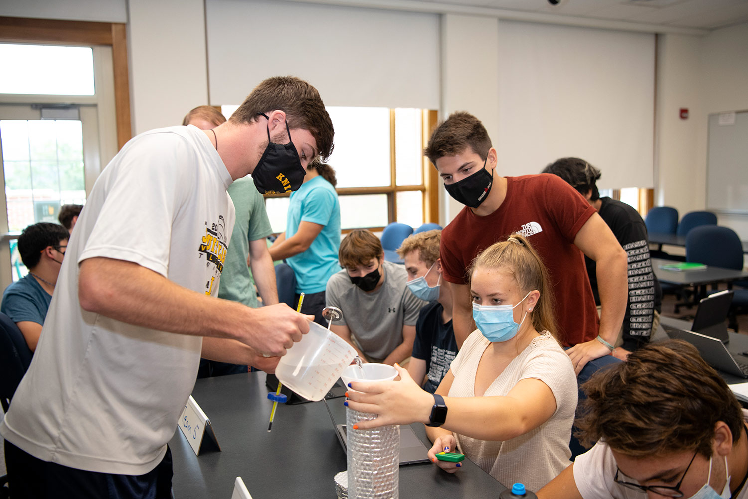 A photograph taken of a student group activity inside a ENGR 100 course at the Bucknell College of Engineering building