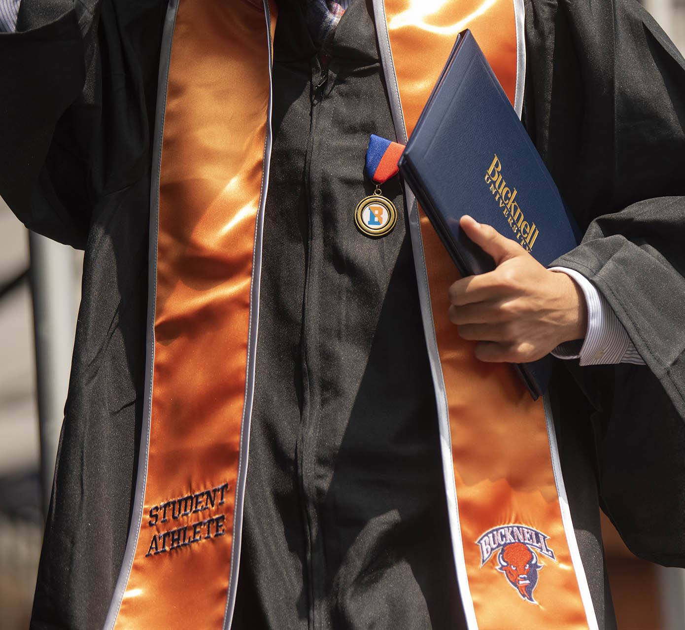 Academic apparel with orange sash