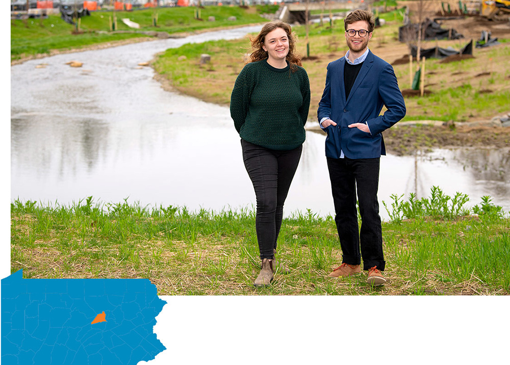 Maggie McConnell and Taylor Lightman, director of the Lewisburg Neighborhoods nonprofit, standing in front of a river