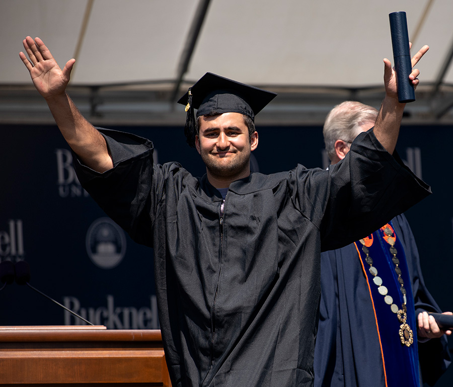 Bucknell graduate raises his hands in celebration
