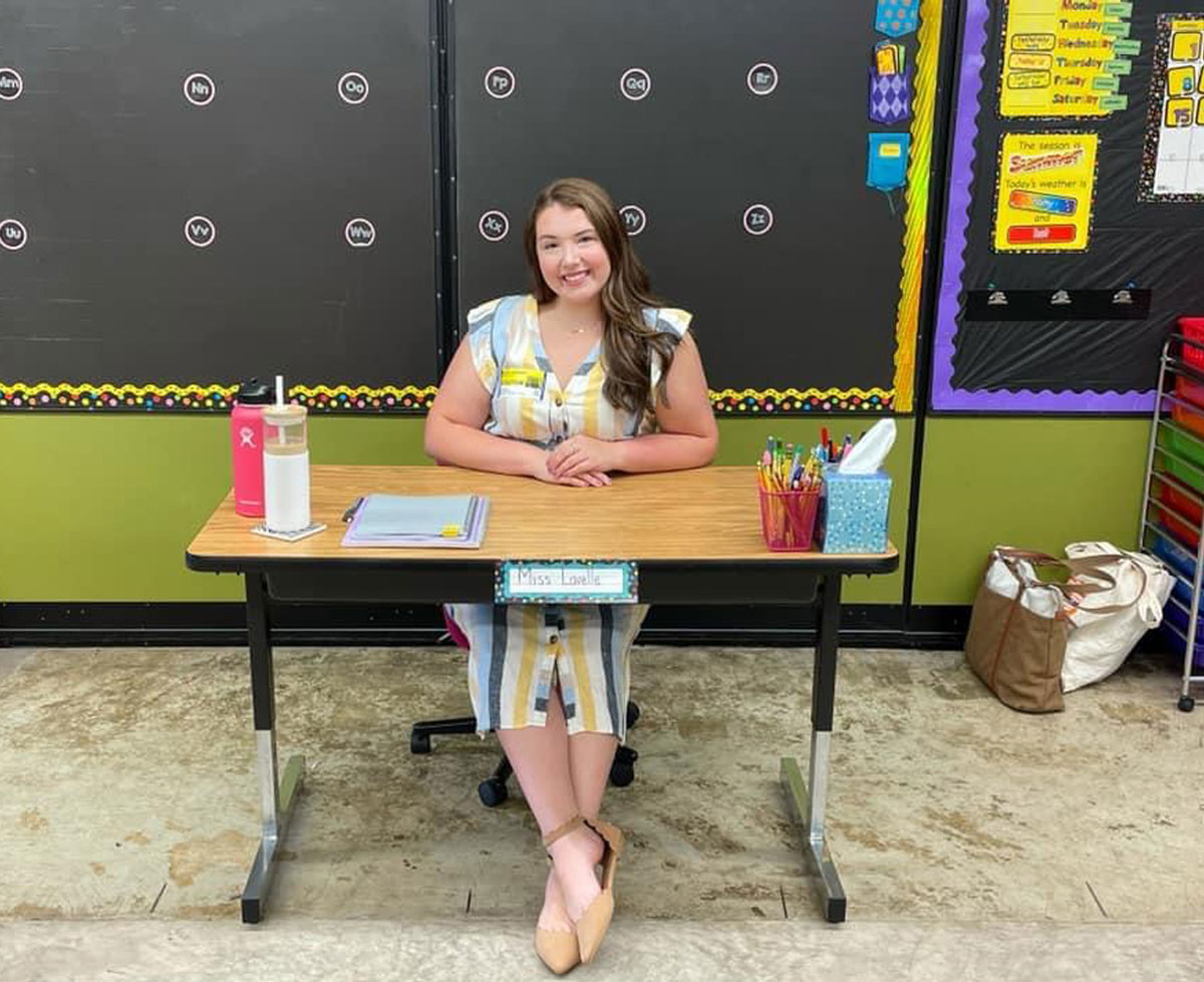 Student teacher sitting at desk