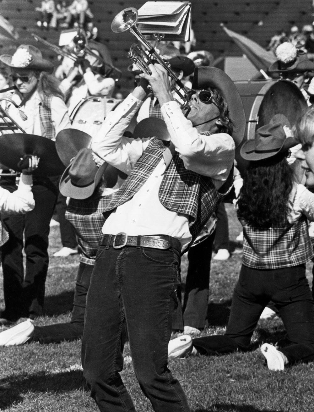 black and white photo of man passionately playing the trumpet