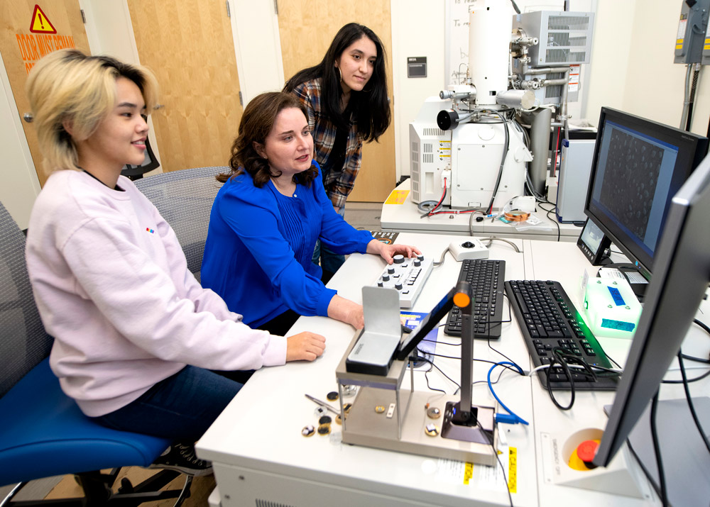 Grace Lostak-Baker, Professor Wendelin Wright, mechanical engineering, and Jazmin Ramirez ’23 examine images collected from a scanning electron microscope