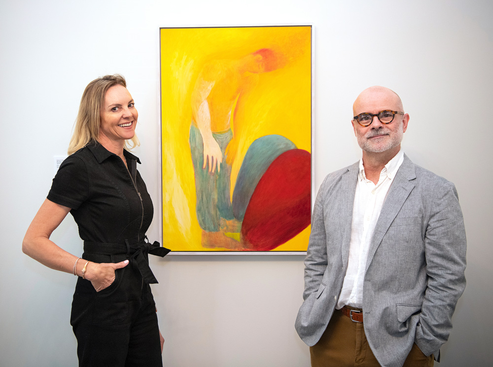 Wendy Quest Trevisani ’92, P’26 and Rick Rinehart standing next to a painting.