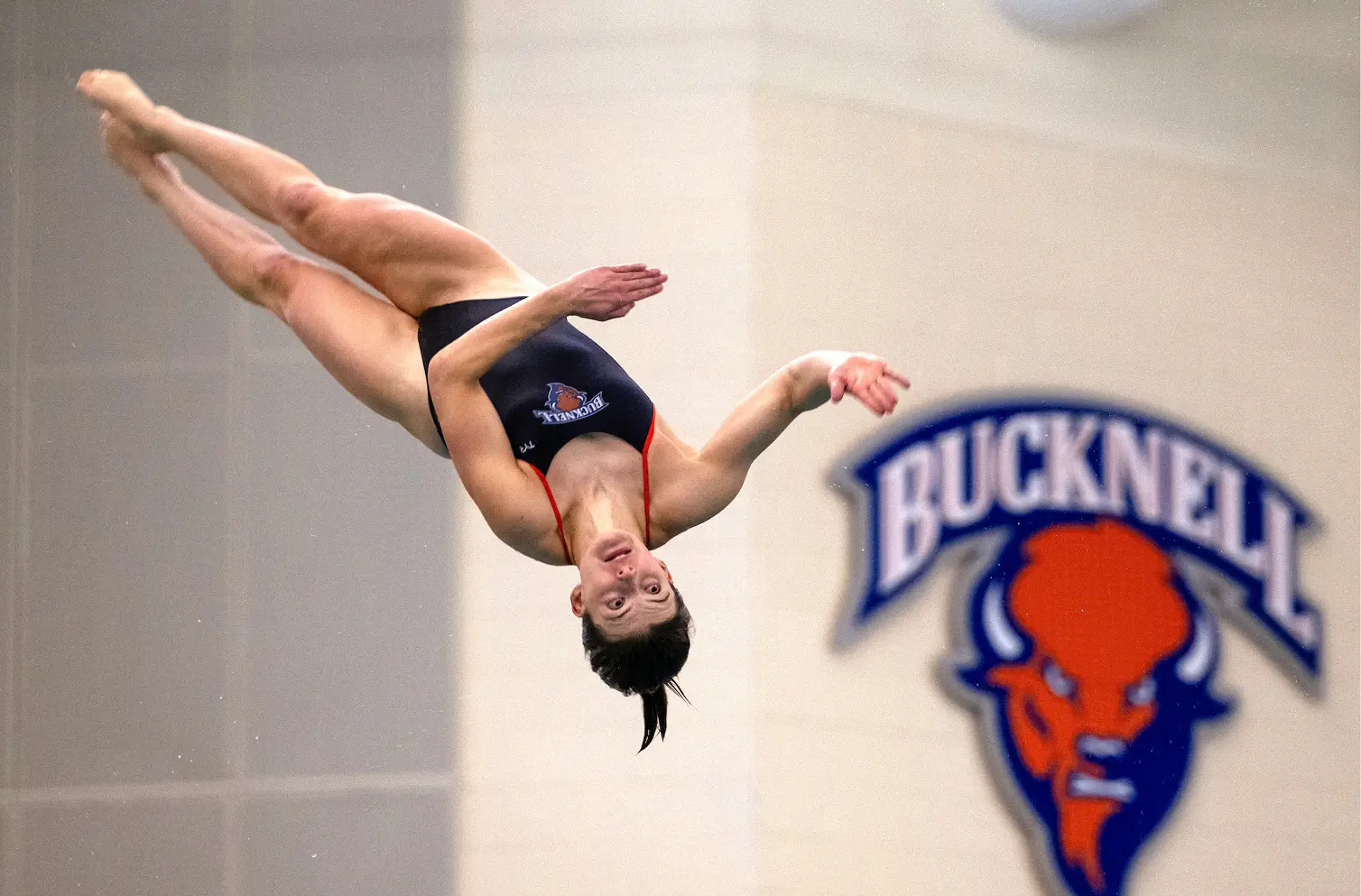 Meghan Catherwood using gymnastics practices as she dives into a pool