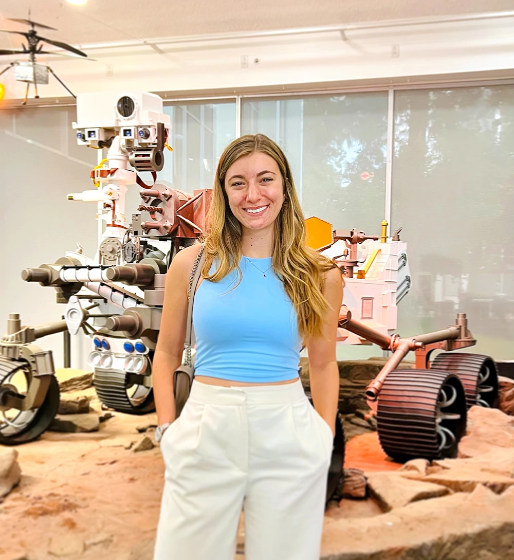 Serena Tramm posing in front of a NASA space rover
