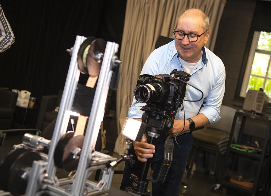 Professor Eric Faden working with a camera