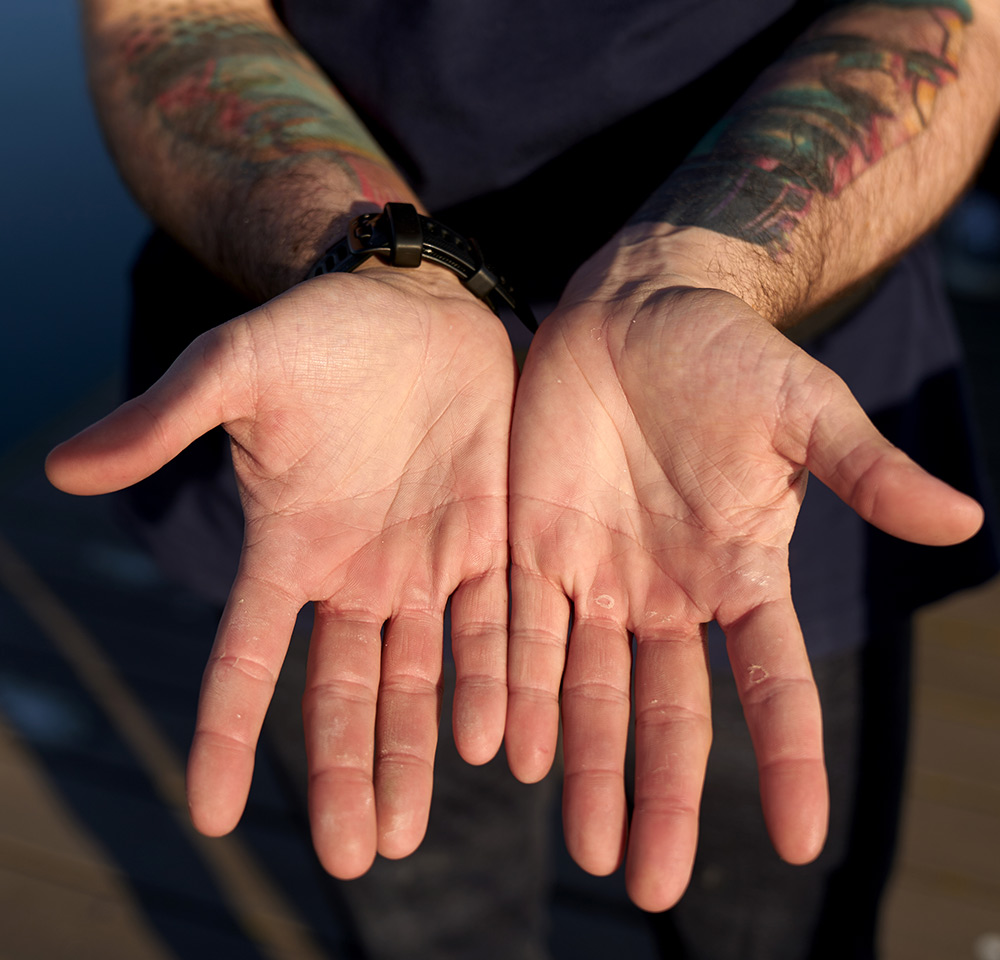 close up of Taylan Stulting hands displaying their hard-earned callouses